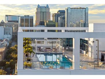 Rooftop pool and lounge area surrounded by city views at 260 S Osceola Ave # 1001, Orlando, FL 32801
