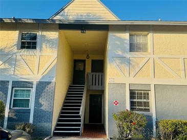 Exterior view of condo building with stairs leading to entrance at 4720 Kilt Ct # 4720, St Cloud, FL 34769