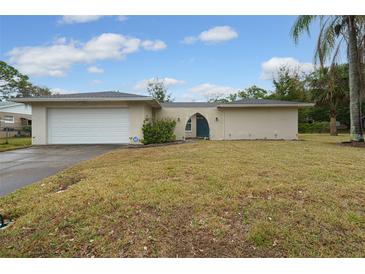 Ranch style home with a white garage door and well-maintained lawn at 507 Applewood Ave, Altamonte Springs, FL 32714