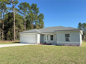 Newly constructed one-story home with a two-car garage and grassy lawn at 6365 Sw 156 Th St St, Ocala, FL 34473