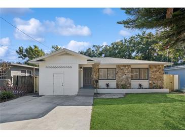 Charming single-story home with a stone facade and well-manicured lawn at 1504 E Robinson St, Orlando, FL 32801