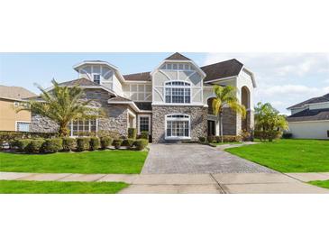 Two-story house with stone accents and a paved driveway at 2555 Rose Spring Dr, Orlando, FL 32825