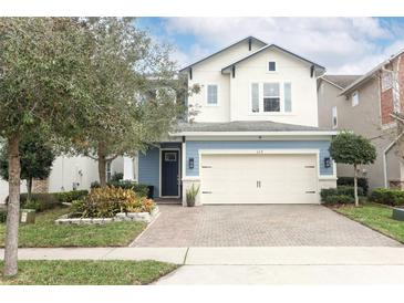 Charming two-story home featuring a 2-car garage and a beautifully landscaped front yard and brick driveway at 618 Windy Pine Way, Oviedo, FL 32765