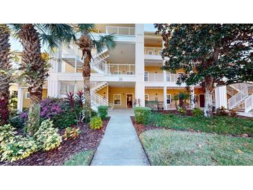 Inviting condo building with lush landscaping and walkway at 702 Rum Run # 38702, Davenport, FL 33897