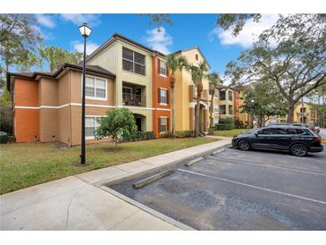 Exterior of a two-story apartment building with ample parking at 814 Crest Pines Dr # 937, Orlando, FL 32828