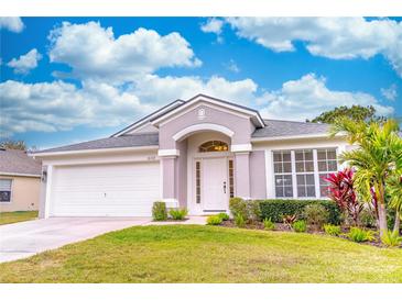 Charming one-story house with a landscaped lawn and attached garage at 1028 Cinnamon Fern Ct, Casselberry, FL 32707