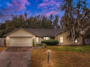 Inviting house exterior at dusk with a two-car garage at 1220 Alden Ter, Deltona, FL 32738