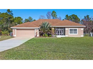 Single-story home with a brown roof, attached garage, and landscaped yard at 18433 Reynolds Pkwy, Orlando, FL 32833