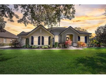 Beautiful two-story house with a landscaped lawn and a brick driveway at 32604 View Haven Ln, Sorrento, FL 32776