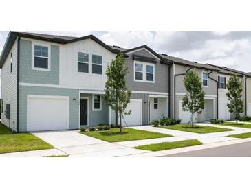 New townhouses with attached garages and landscaping at 3265 Vesara Dr, Davenport, FL 33837