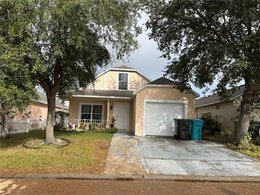 Cute one-story house with a white door and garage at 5453 Wood Crossing St, Orlando, FL 32811