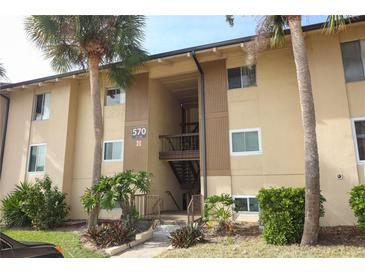 Tan building exterior with stairs and palm trees at 570 Orange Dr # 51, Altamonte Springs, FL 32701