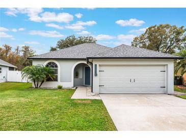 Gray house with a two-car garage and well-manicured lawn at 1698 Riveredge Rd, Oviedo, FL 32766