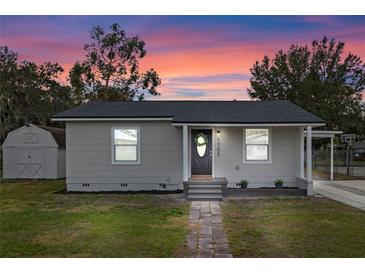 Newly renovated house with gray exterior, walkway, and a small shed at 1703 E Fern Rd, Lakeland, FL 33801