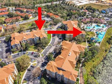 Aerial view of condo community, showing building exteriors and resort-style pool at 2821 Almaton Loop # 303, Kissimmee, FL 34747