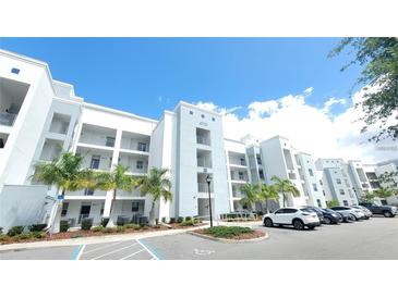 Modern apartment building with ample parking and landscaping at 4731 Clock Tower Dr # 203, Kissimmee, FL 34746