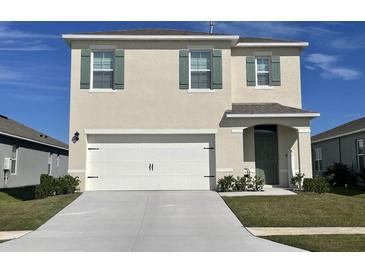 Two-story house with a white garage door and green shutters at 4823 Cranberry Way, Lakeland, FL 33811