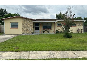 Ranch style home with stone accents and a well-maintained lawn at 5550 Showalter Dr, Orlando, FL 32839