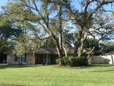 Brick house with mature oak trees and a well-maintained lawn at 749 E Yorkshire Dr, Deland, FL 32724