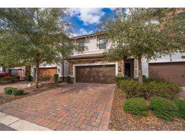 Attractive townhome with two-car garage and brick paver driveway at 8545 Couples St, Davenport, FL 33896