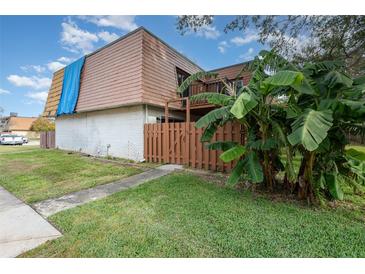 Two-story condo building with brown roof and wooden fence at 95 Moonstone Ct, Port Orange, FL 32129