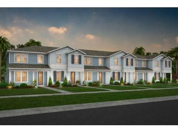 Modern townhome community with attached garages and landscaped yards at 11175 Rising Sun St, Orlando, FL 32829