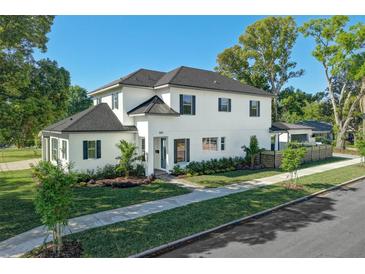 Beautiful two-story home with a well-manicured lawn and mature landscaping at 500 W Hazel St, Orlando, FL 32804