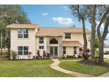 Two-story house with stone accents and landscaping at 5032 River Lake Rd, Winter Haven, FL 33884