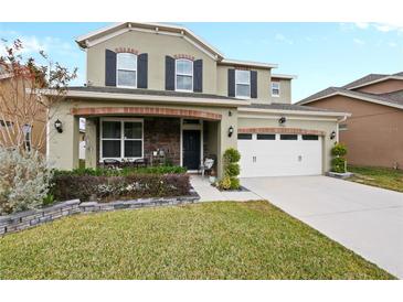 Two-story house with a two-car garage and landscaped front yard at 7043 Oxbow Rd, Minneola, FL 34715
