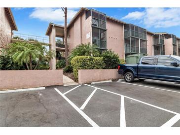 Exterior view of condo building with parking and landscaping at 122 Water Front Way # 370, Altamonte Springs, FL 32701