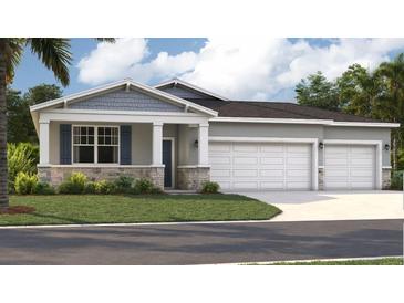 Charming single-story home features a stone facade, blue shutters, and a three-car garage at 12795 Trovita Dr, Grand Island, FL 32735