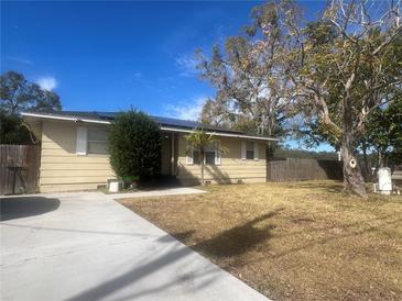 Ranch style home with a spacious front yard and mature trees at 1606 Lime St, Kissimmee, FL 34746