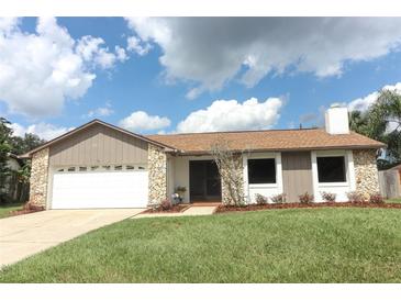 Updated single-story home with a stone facade and a two-car garage at 1710 Aster Dr, Winter Park, FL 32792