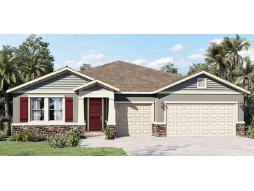 Two-story home with neutral siding, two-car garage, and red shutters at 3214 Arch Ave, Ormond Beach, FL 32174