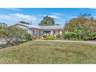 Ranch-style home with mature landscaping and a spacious yard at 4437 Elaine Pl, Orlando, FL 32812