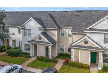Two-story townhouses with gray roofs, light-colored siding, and landscaping at 142 Southern Pecan Cir # 207, Winter Garden, FL 34787