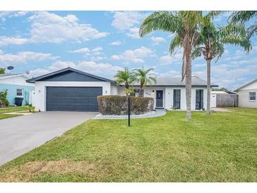 Updated home exterior boasts a modern design, fresh landscaping, and a spacious driveway at 2932 Carriage Dr, Daytona Beach, FL 32119