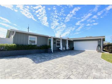Gray house with a white garage and a paved driveway at 326 Benton St, Orlando, FL 32839