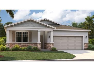 One-story home with gray siding, stone accents, and a two-car garage at 9154 Harris Hawk Dr, Leesburg, FL 34788