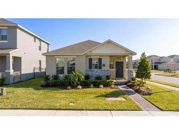 One-story home with stone accents, landscaping, and a brick walkway at 16626 Point Rock Dr, Winter Garden, FL 34787