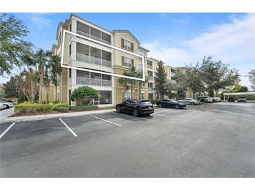 Condo building with parking lot and landscaping at 3362 Robert Trent Jones Dr # 30307, Orlando, FL 32835