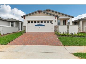 Two-story house with brick driveway and landscaping at 511 Kennedy Dr, Lake Alfred, FL 33850