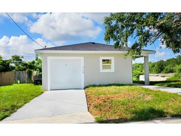 Newly constructed home with attached garage and driveway at 6120 Denson Dr, Orlando, FL 32808