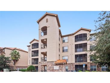 Attractive 3-story condo building with balconies and stone accents at 8010 Tuscany Way # 5302, Davenport, FL 33896