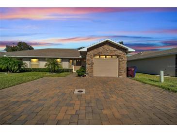 Inviting exterior with stone accents and a paved driveway at 1748 Christina Lee Lane, St Cloud, FL 34769