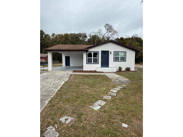 Newly renovated home with a modern exterior, driveway, and landscaped yard at 1821 Rogers Ave, Maitland, FL 32751
