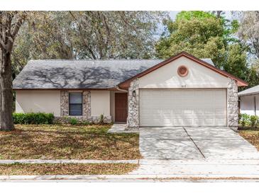 Charming single-story home with a two-car garage and stone accents at 512 Holbrook Cir, Lake Mary, FL 32746