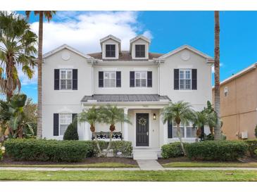 Two-story house with a front porch and landscaping at 7400 Soiree Way, Reunion, FL 34747