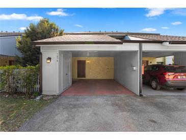 Covered carport with space for one car and extra storage at 7474 Canford Ct # 13, Winter Park, FL 32792