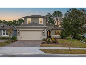 Charming two-story home with a well-manicured lawn, lovely landscaping, and a spacious two car garage at 223 Cherokee Hill, Deland, FL 32724